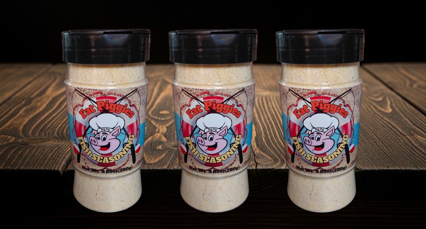 Fat Piggies Fish Seasoning bottle on the counter with the rub lineup behind it